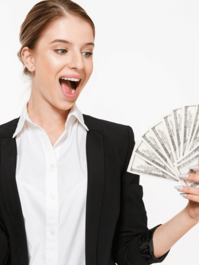 Happy business woman holding money