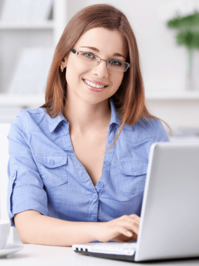young girl smiling using laptop