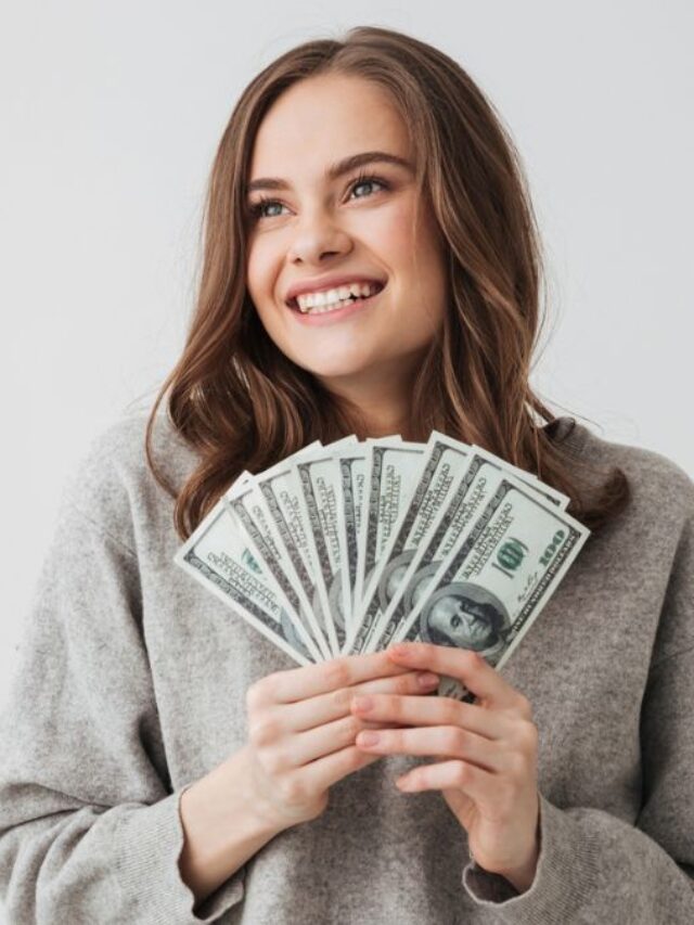 Woman Smiling Looking At The Side Holding Money Bills
