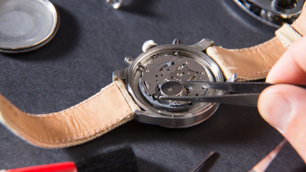 Person Fixing Watch Battery