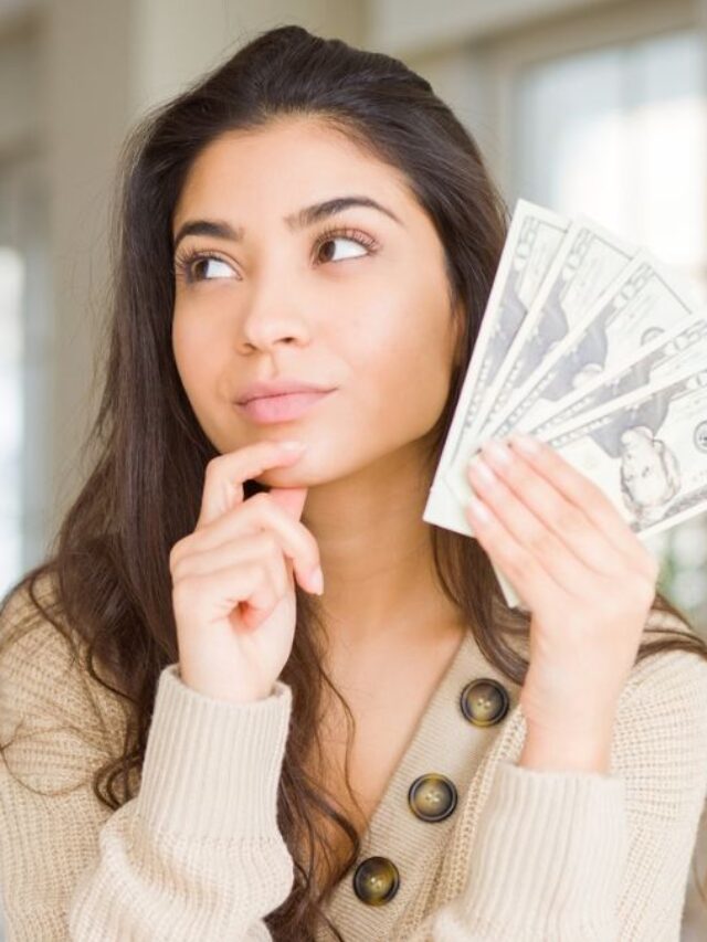 Young Woman Thinking While Holding Dollar Bills Cash Money MSN