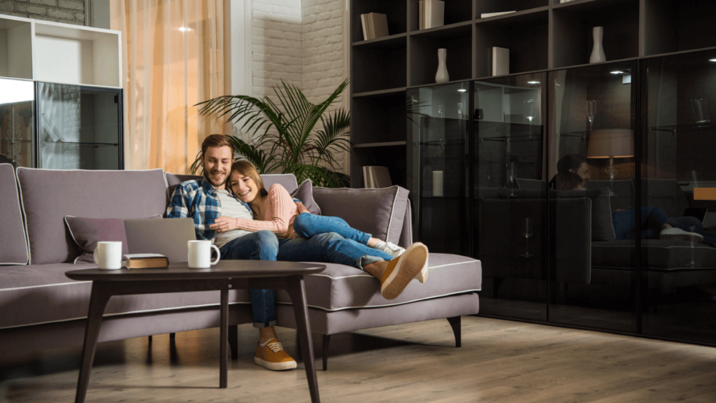Man and Woman Lying on Couch Relaxing House Home MSN