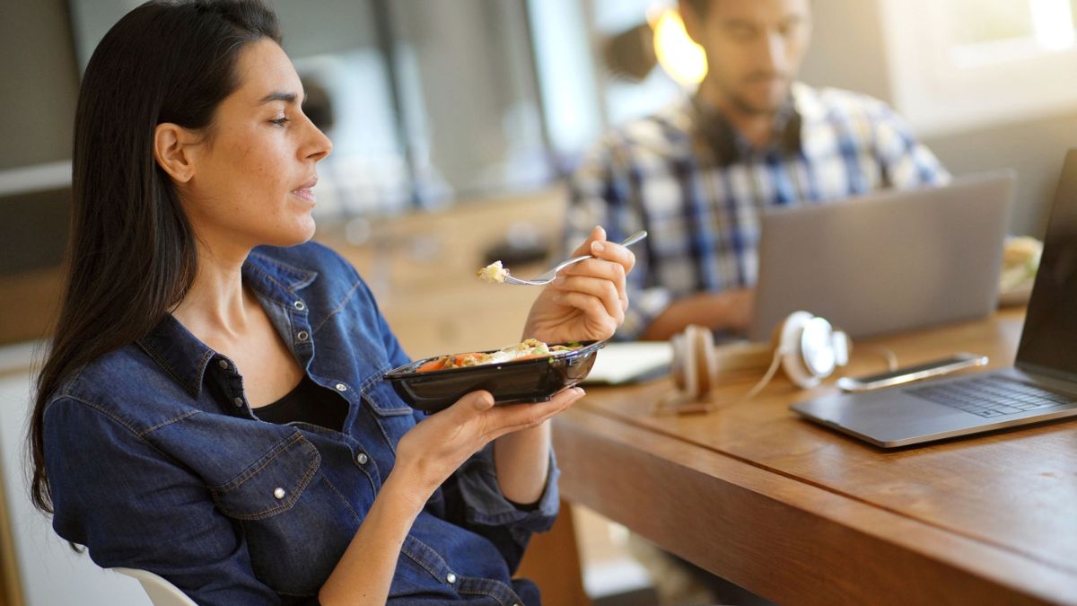 Woman Eating Lunch At Work