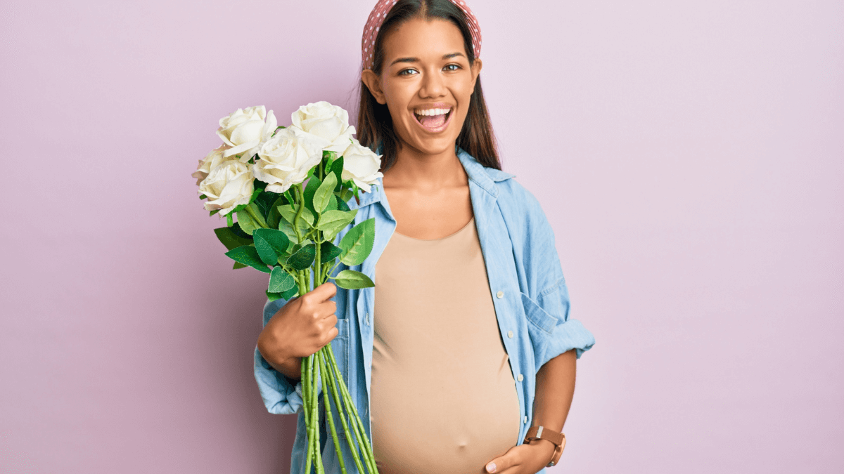 Pregnant Woman Holding Flowers Smiling MSN