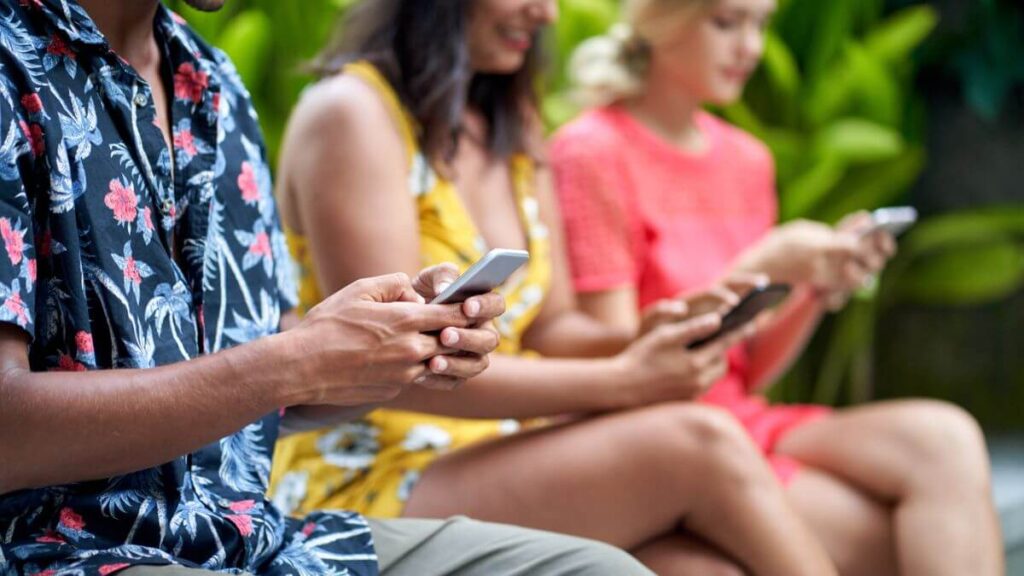 Three People Seated Holding Smartphones MSN
