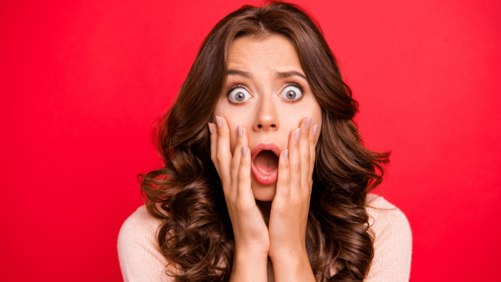 Woman Looking Shocked and Surprised on Red Background MSN