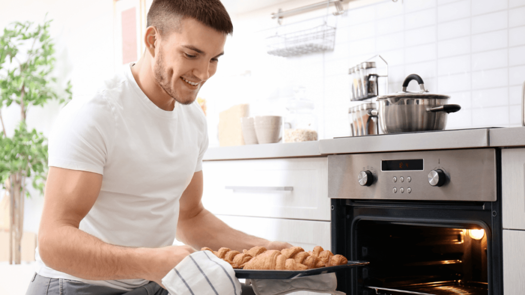 Man Baking Taking Baked Goods From Oven MSN