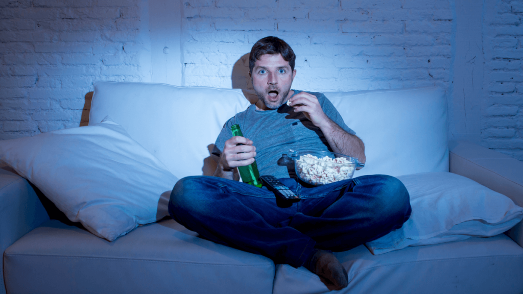 Man Watching Movie or Cable TV With Popcorn and Looking Amazed MSN