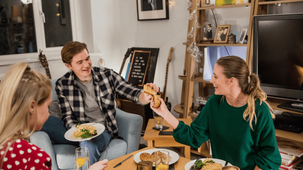People Having Dinner Party Breaking Bread and Eating Pasta MSN