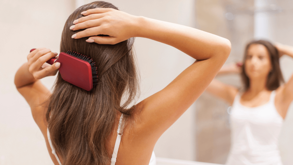 Woman Brushing Hair in Front of Mirror MSN