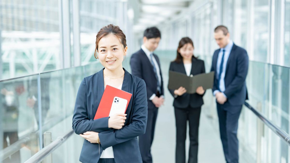 Businesswoman Standing In Front Of Coworkers MSN