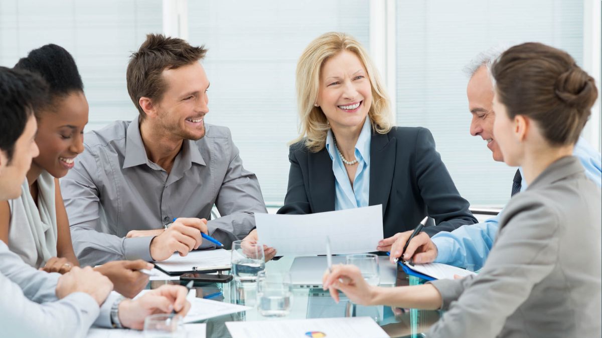 Employees Smiling In Team Meeting MSN