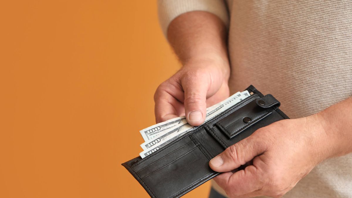 Man Holding Cash In Wallet MSN