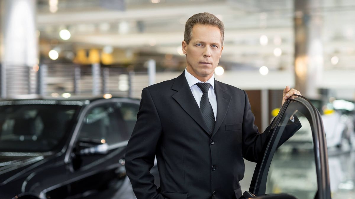 Man In Suit Holding Car Door MSN