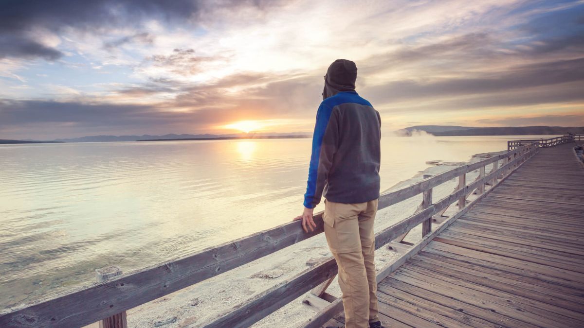 Man Standing On Pier Looking At Sunset MSN
