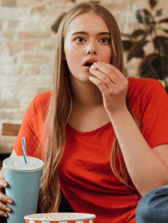 Woman Eating Popcorn Watching a Movie and Looking Chill MSN