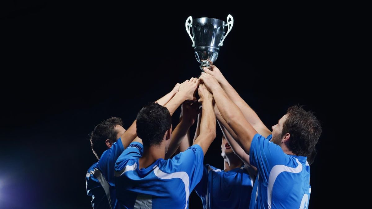 Football Team Celebrating Victory Holding Trophy MSN
