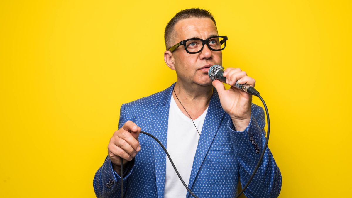 Middle Aged Man In Suit Singing With Microphone MSN