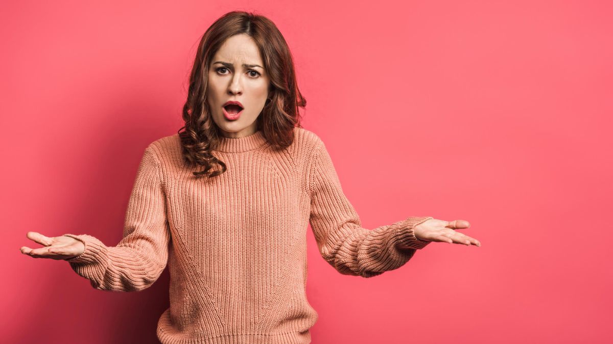Offended Woman Standing With Open Arms On Pink Background MSN