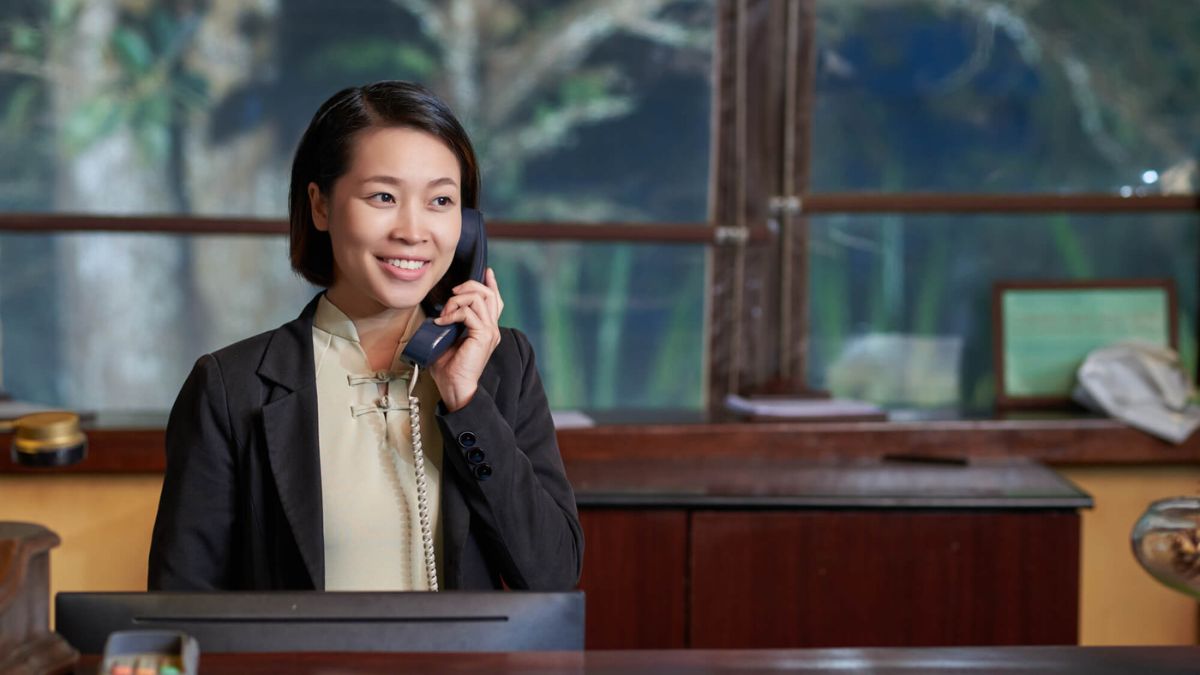 Receptionist At A Desk Calling Phone MSN