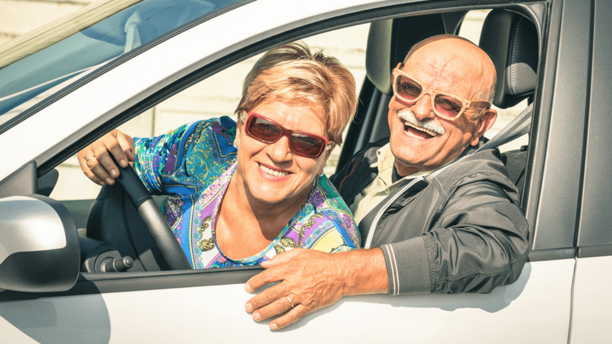 Senior couple smiling driving car - MSN