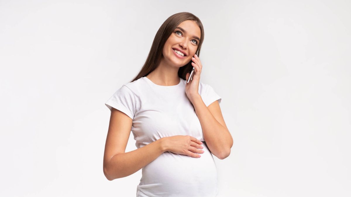 Smiling Pregnant Woman Talking On Phone MSN