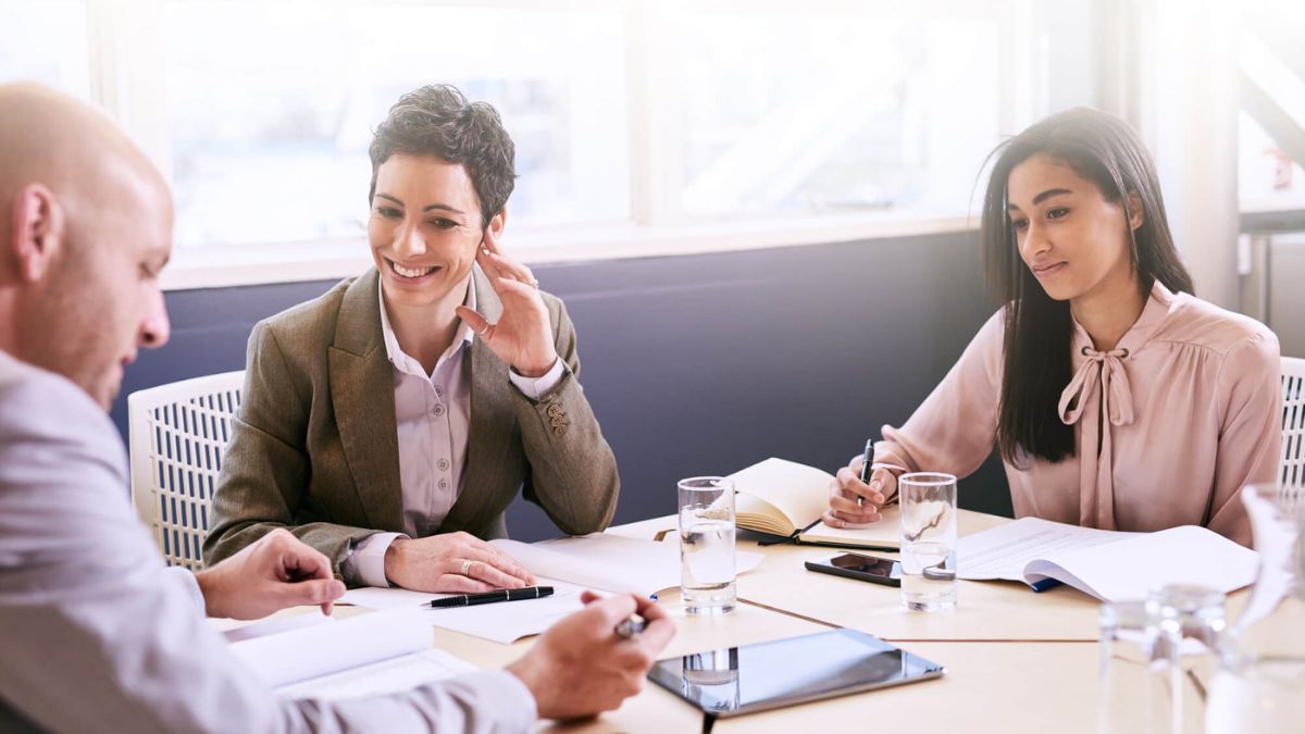 Three Professionals At A Business Meeting MSN
