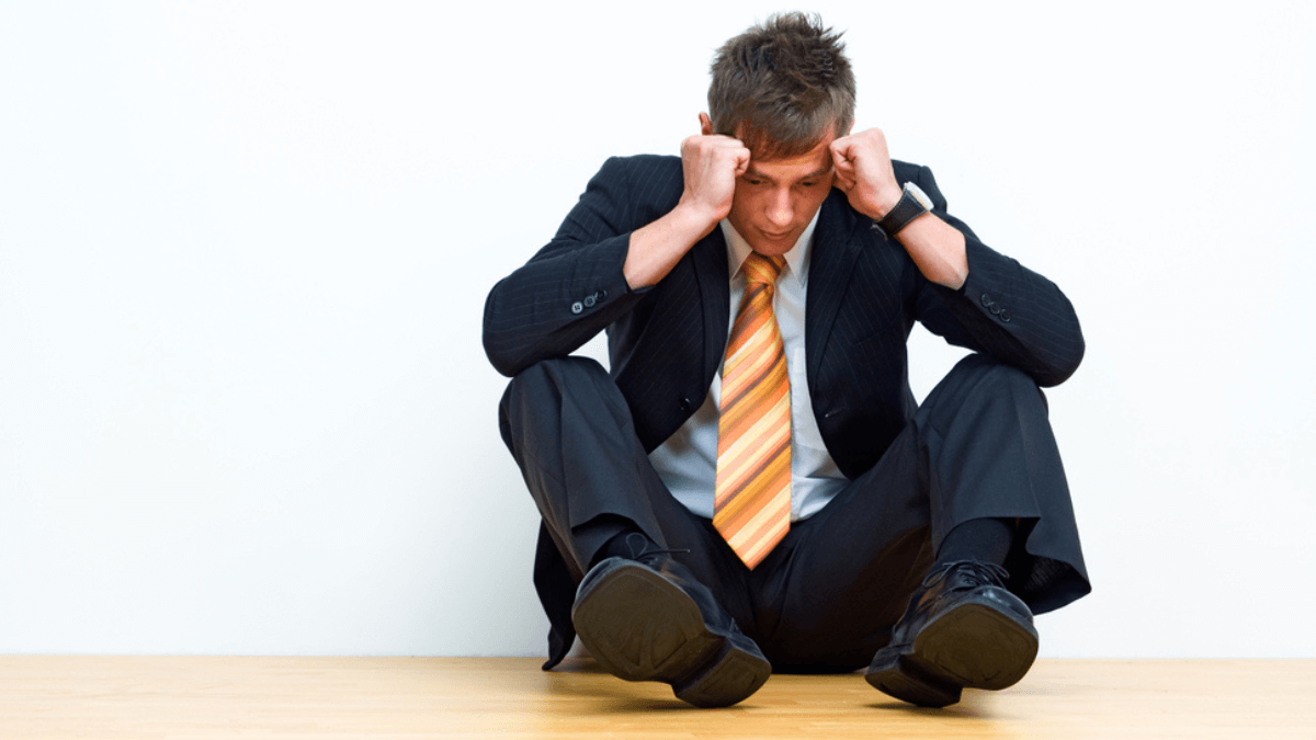 Unhappy man sitting on the floor - MSN
