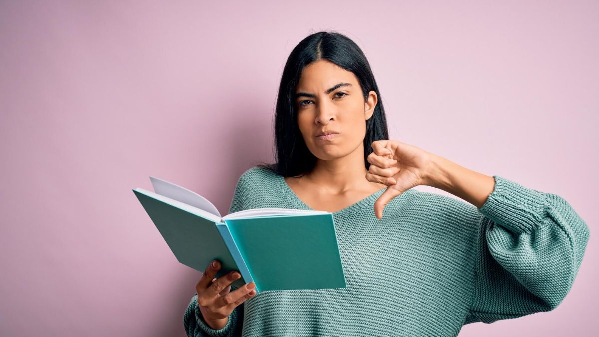 Woman Holding Book Thumbs Down MSN