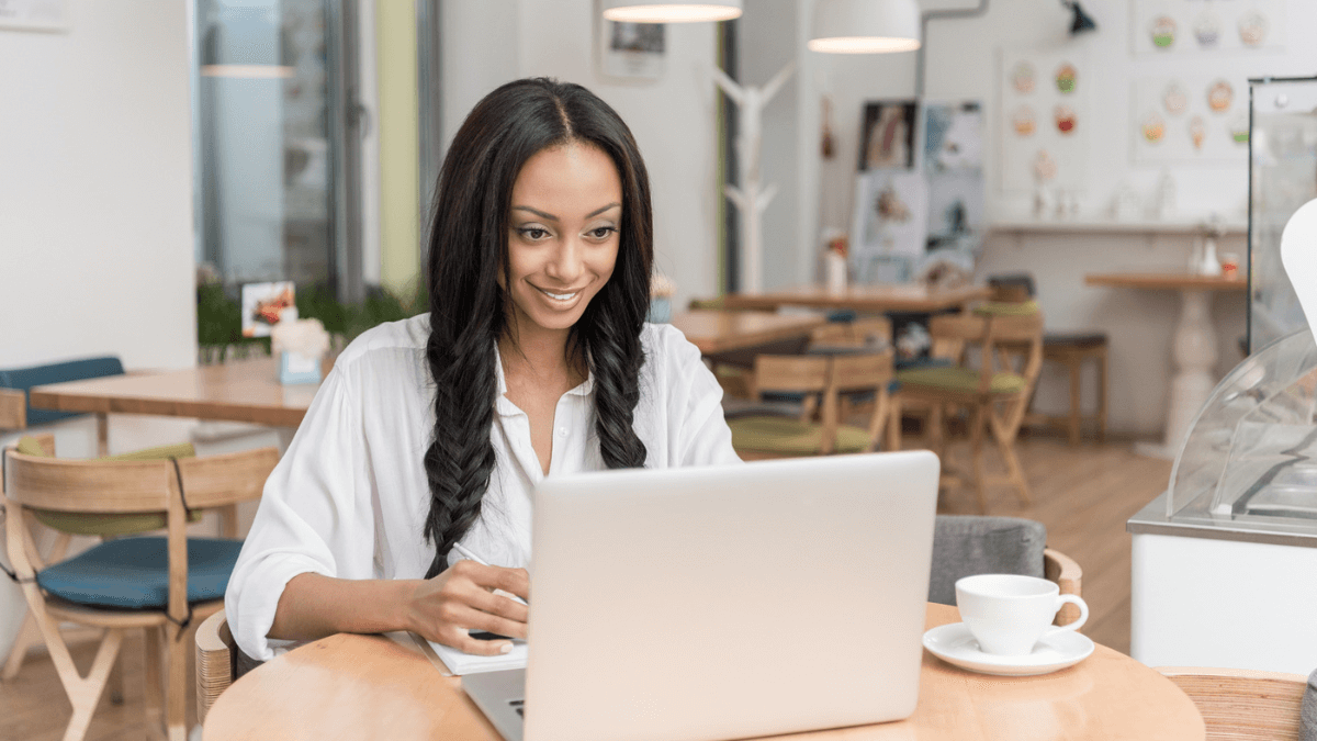 Businesswoman with laptop at cafe