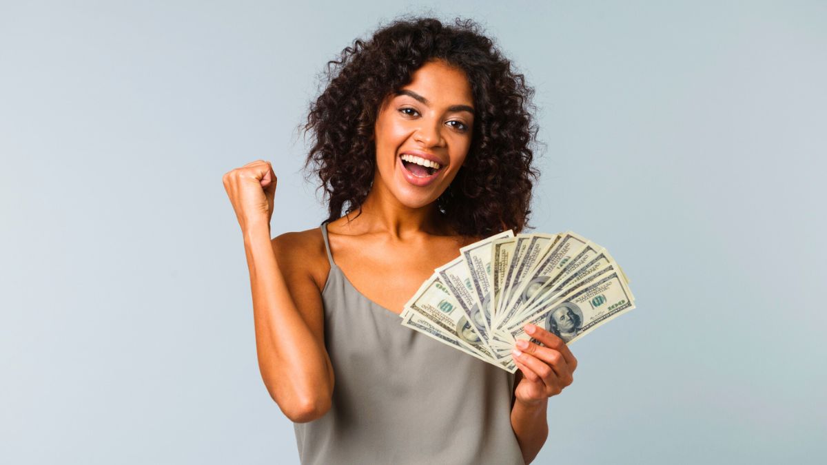 Smiling Woman Holding Money MSN