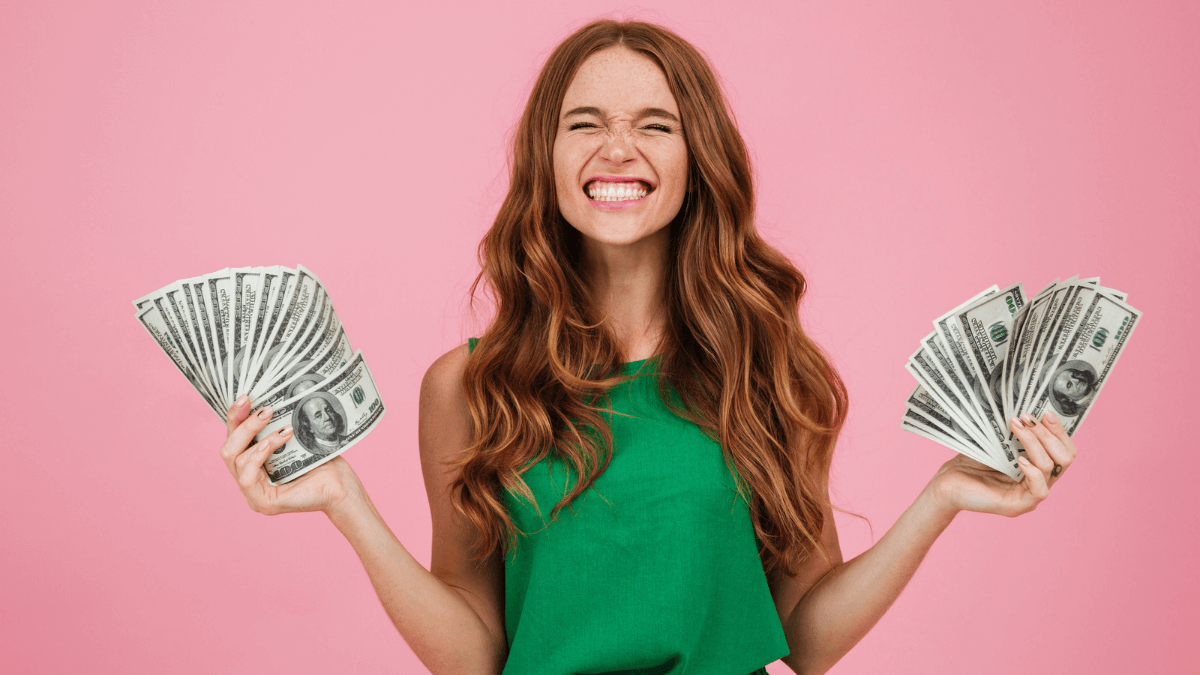 Happy woman with money on both hands
