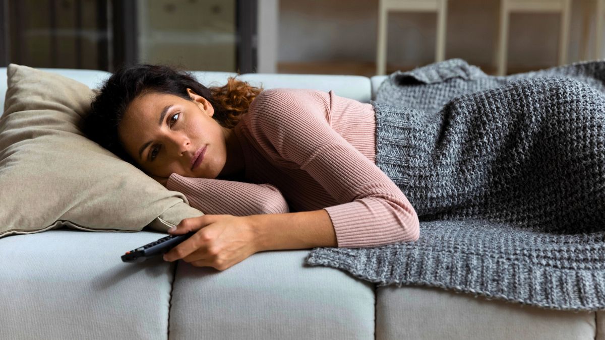 Sad Woman Lying Down While Watching MSN