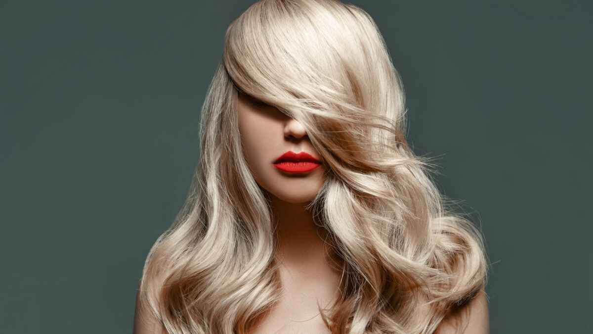 Elegant woman with long blonde hair and striking red lips MSN.