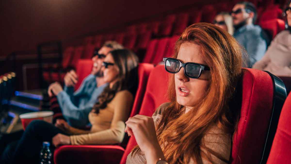 Confused woman watching a movie in the theatre.
