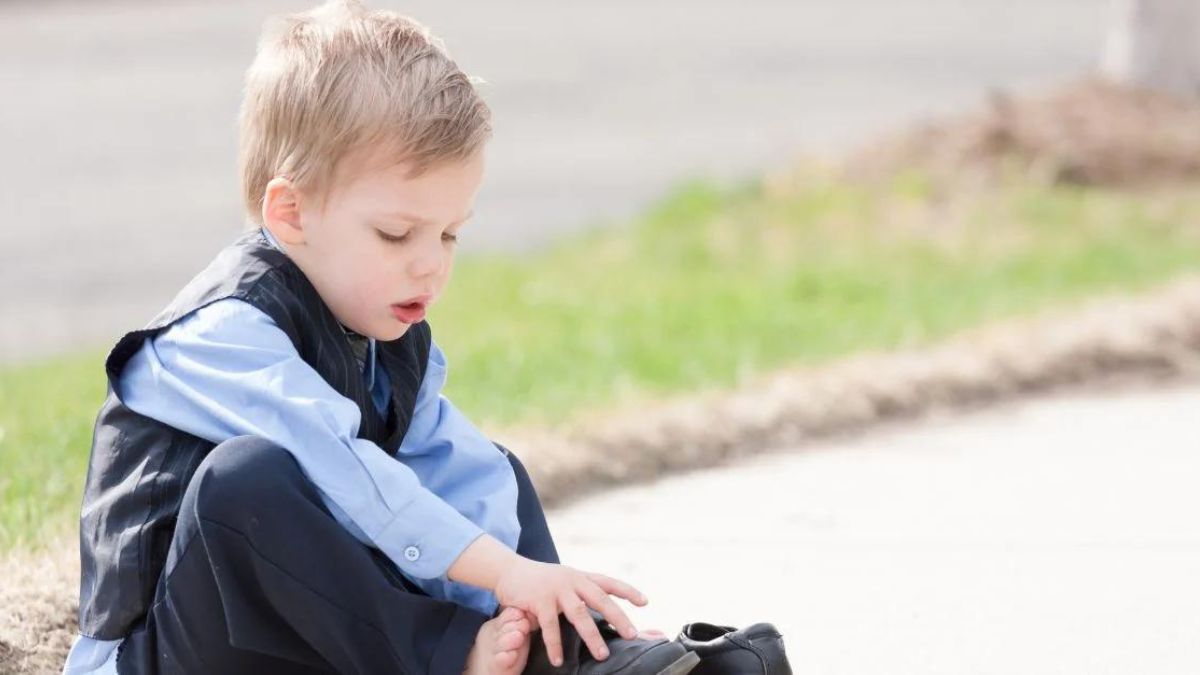 Little boy trying to wear his shoes on his own MSN