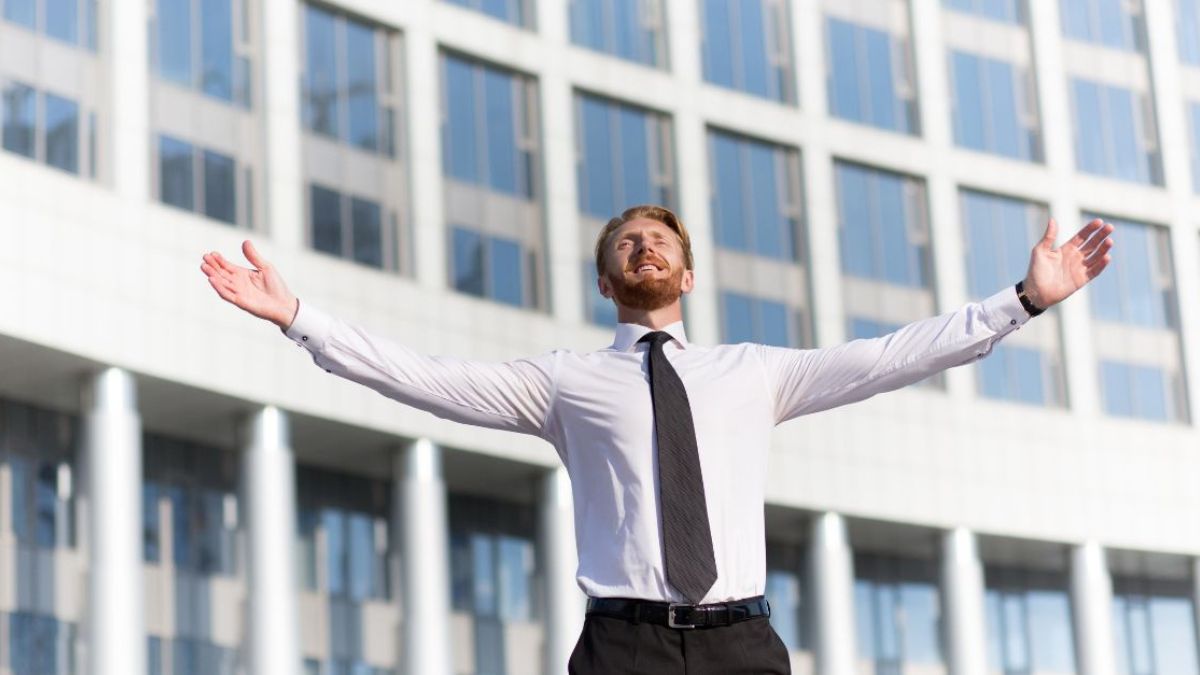 Man happily raising his both hands in the air MSN