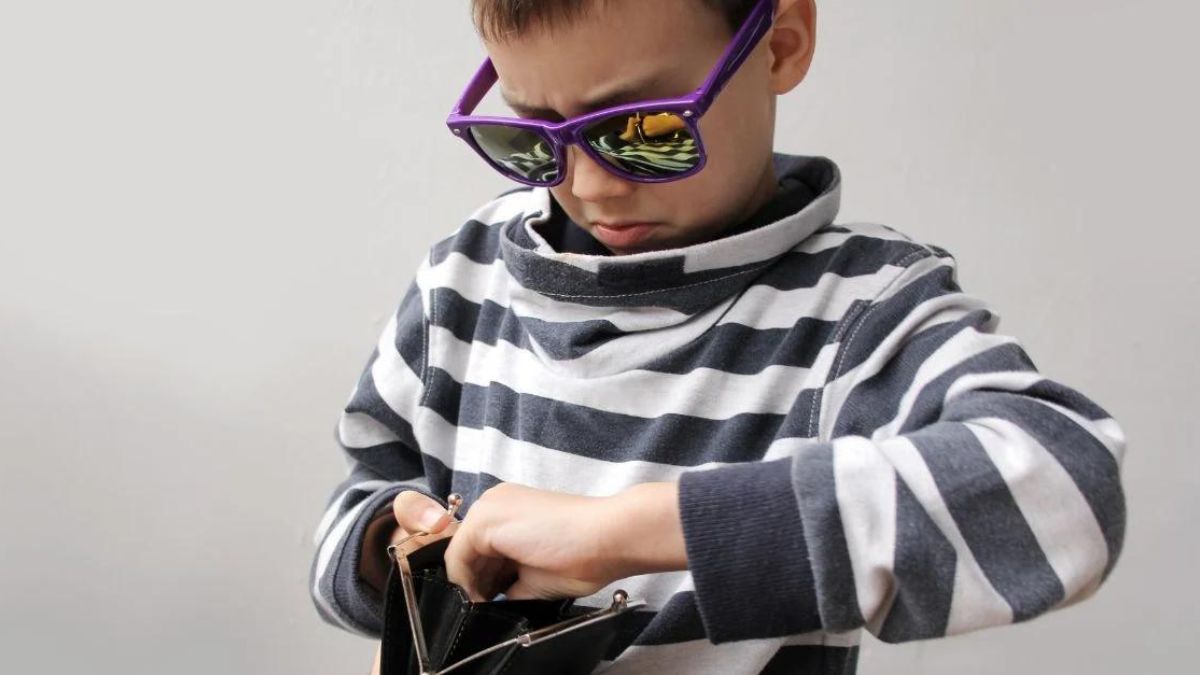 Fashionable little boy getting money from a purse MSN