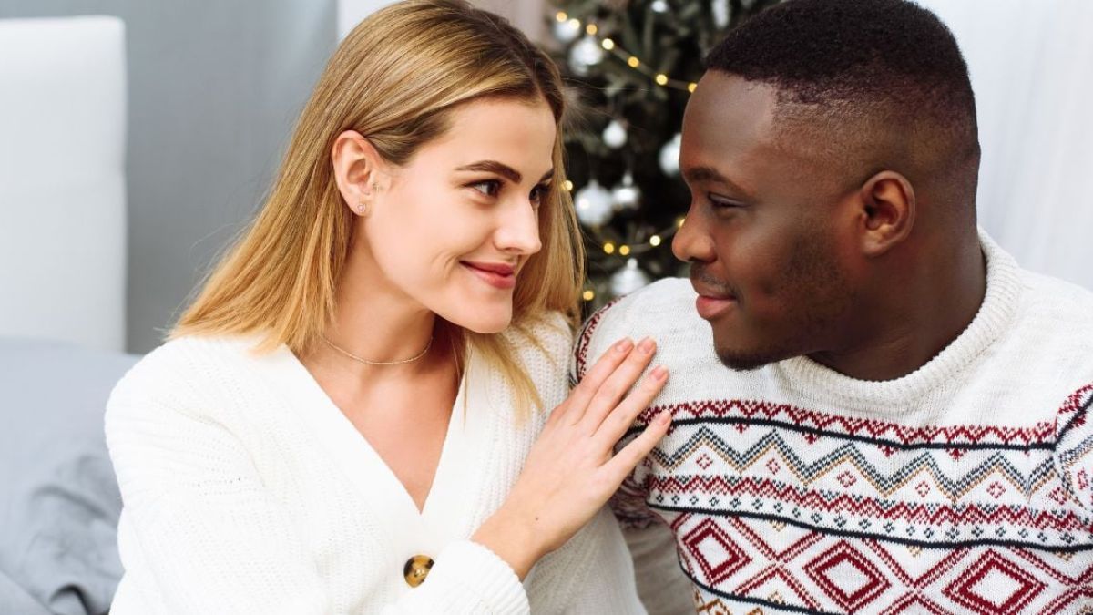 White woman putting one hand on the black man's shoulder while staring at each other sweetly MSN