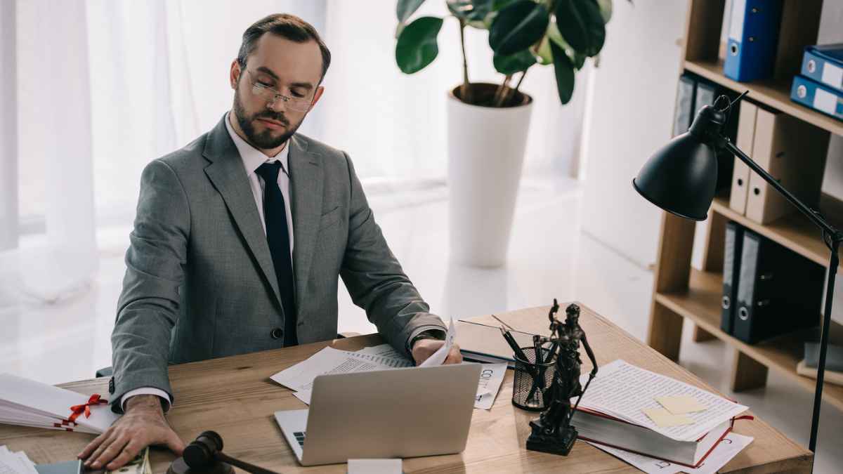 Lawyer eyeglasses taking bribe workplace laptop documents office MSN