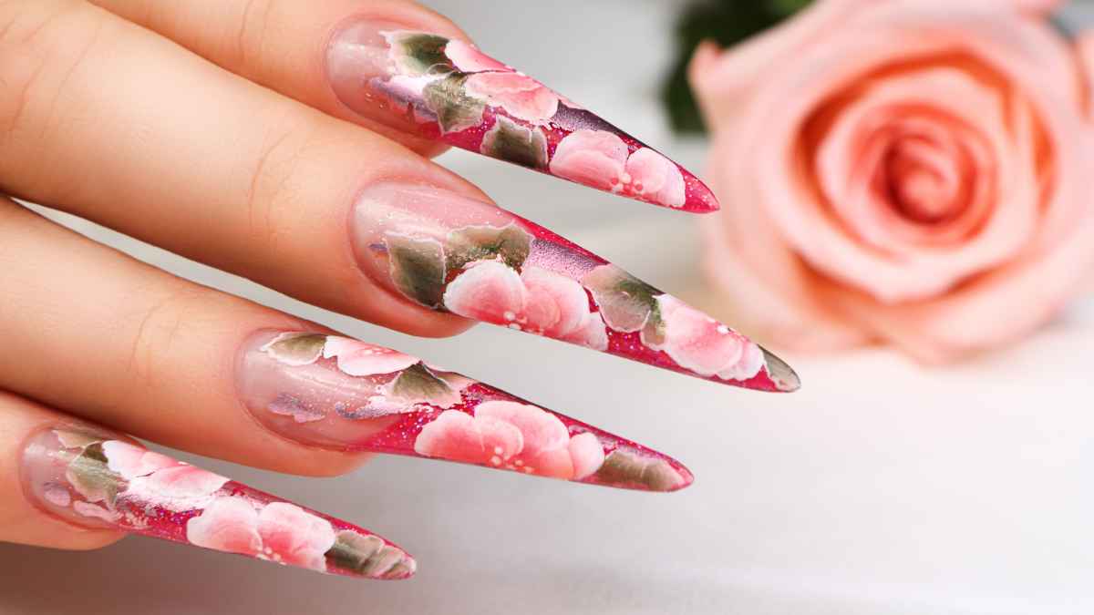 A woman's hand with pink flowers painted on her nails MSN.