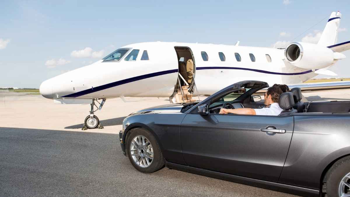 A person in a car with a plane in the background MSN.