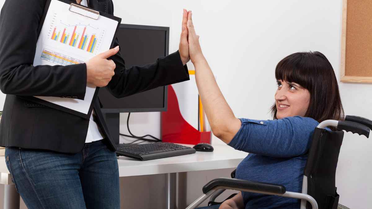 A woman giving a high five to a woman in wheelchair MSN.