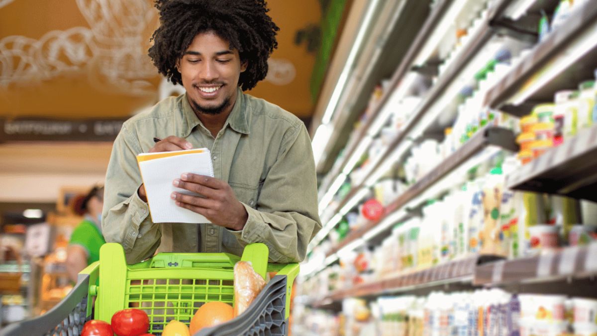 Man happily checking out his grocery checklist MSN