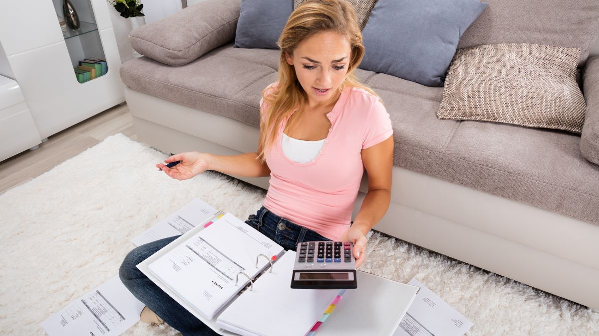 woman seriously calculating her expenses MSN