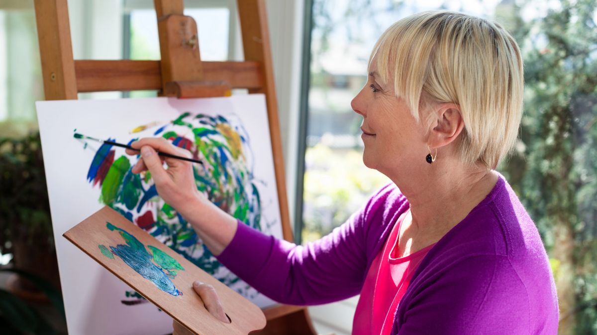 Middle-aged woman painting her heart's out MSN
