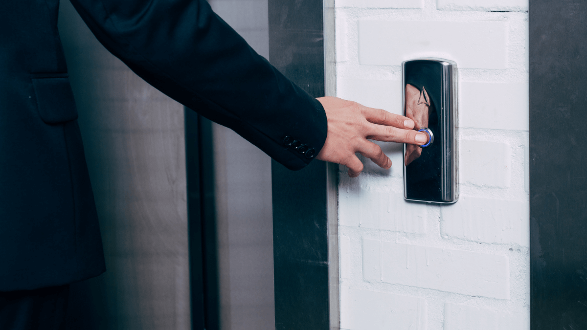 Man pressing elevator button
