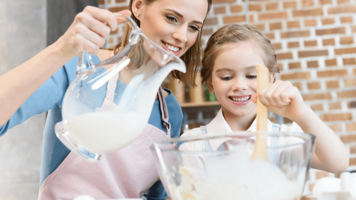 Mother and daughter making dough in mixing bowl MSN
