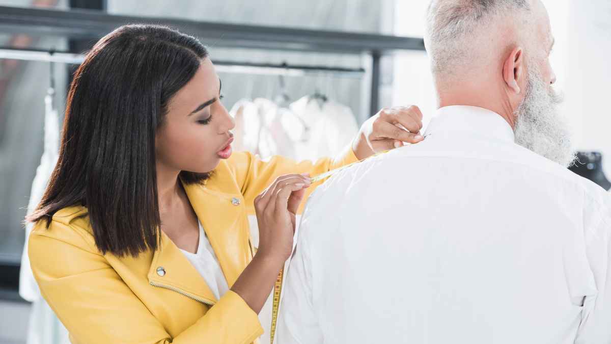 Woman measuring a man's back MSN tailor
