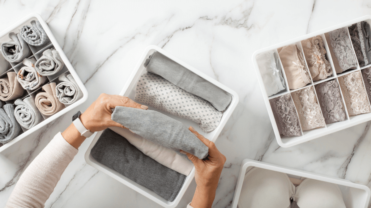 Woman neatly folding undergarments MSN